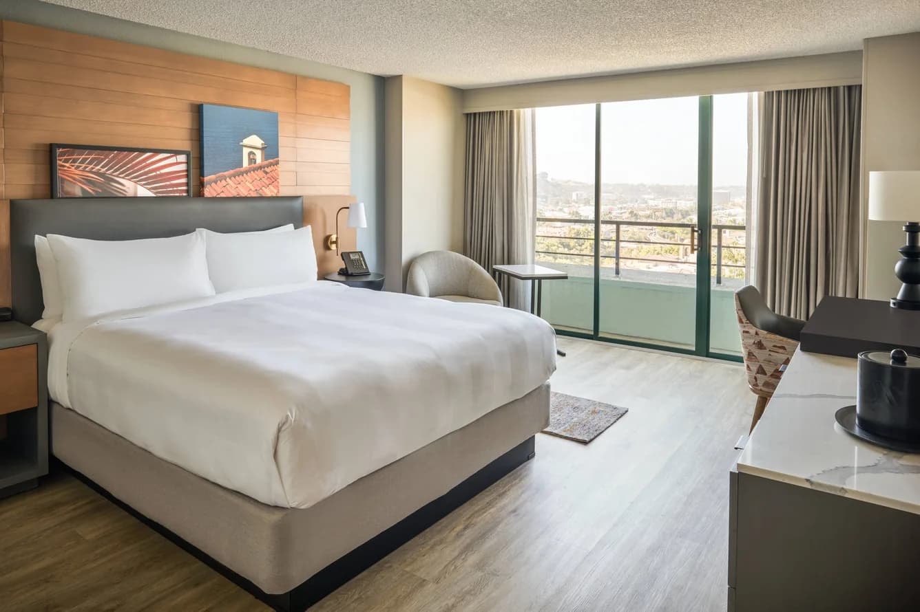 Bright king corner guest room with a balcony and Mission Valley views at San Diego Marriott Mission Valley