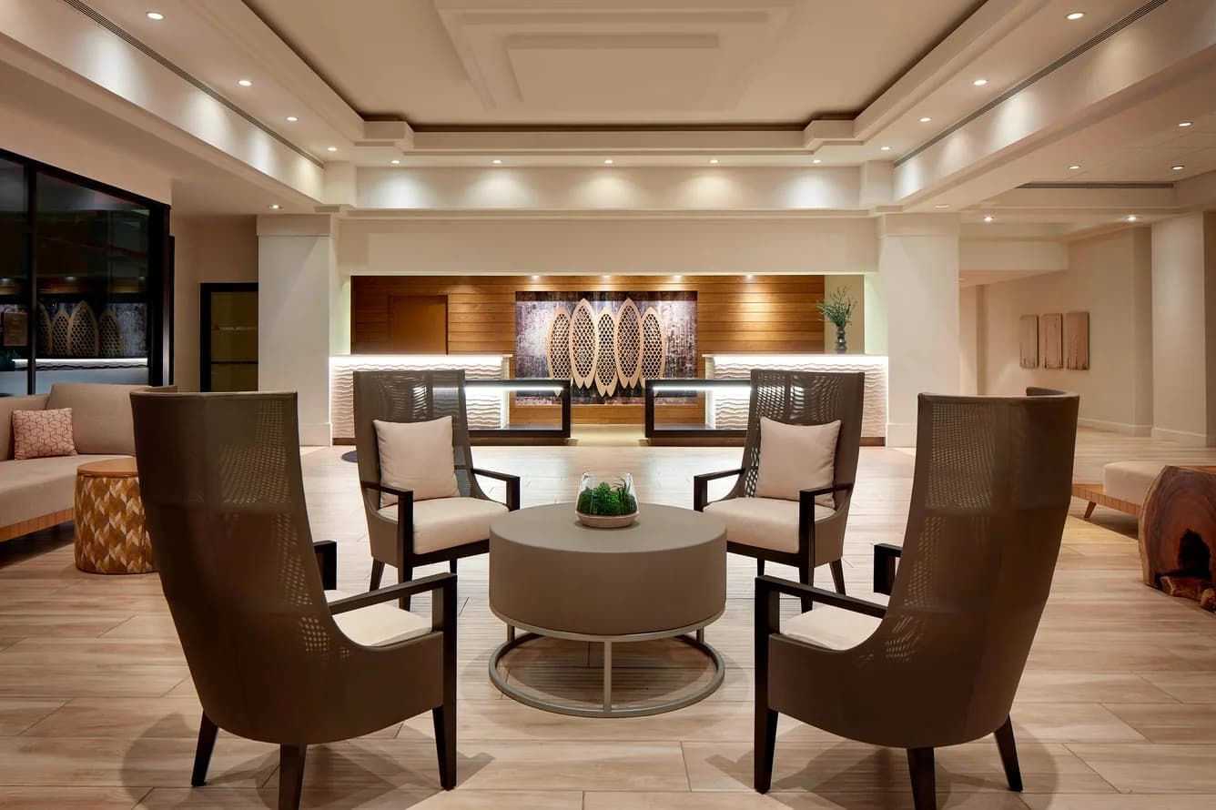 Warmly lit lobby with lounge chairs and a central seating area at San Diego Marriott Mission Valley