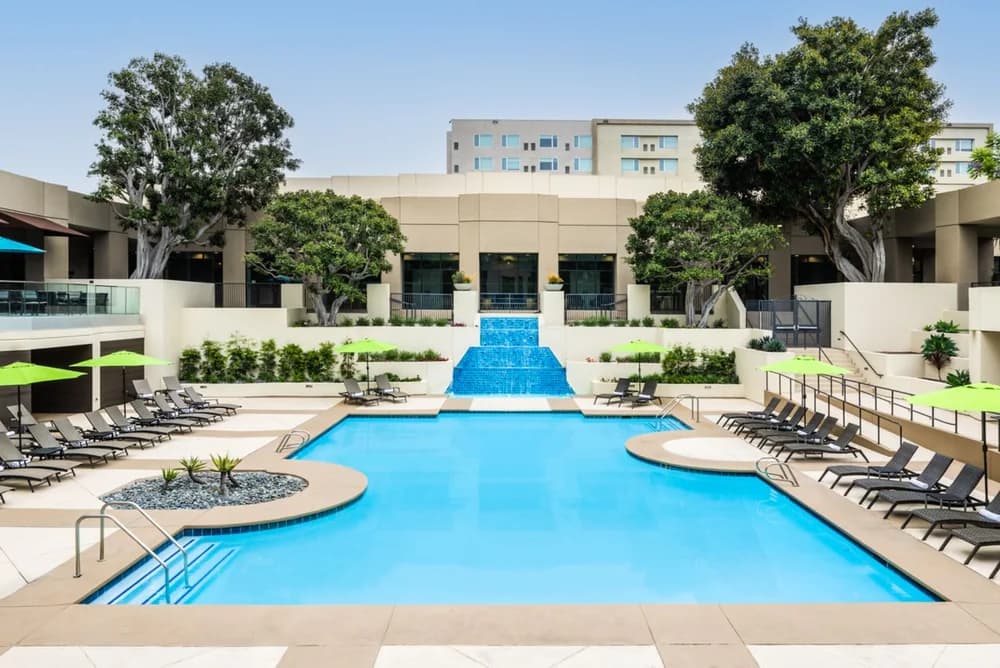 Outdoor pool, cascading fountain and sun loungers at San Diego Marriott Mission Valley