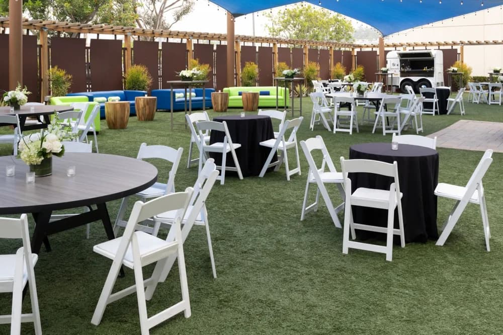 West Lawn reception space with outdoor seating and string lights at San Diego Marriott Mission Valley
